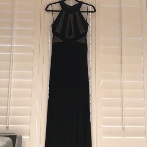 Full length black dress with slit on the left leg.